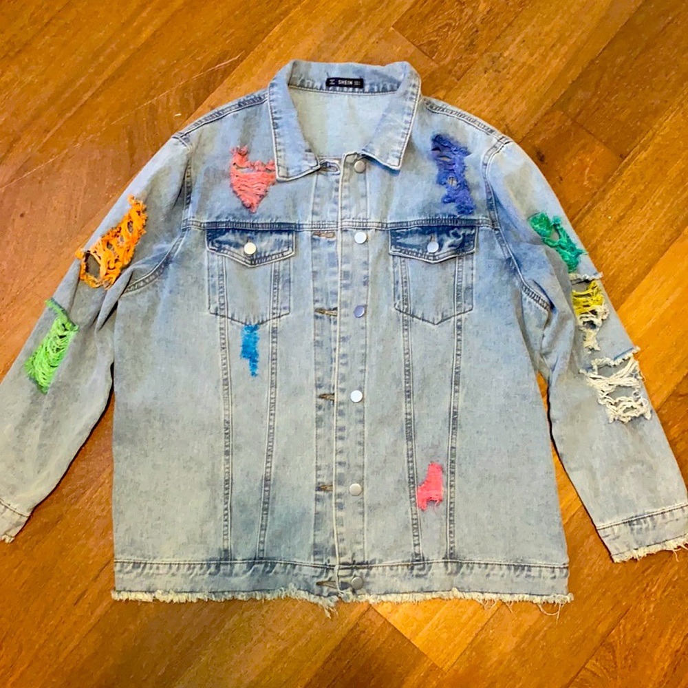 Small light blue jean jacket with colorful rips